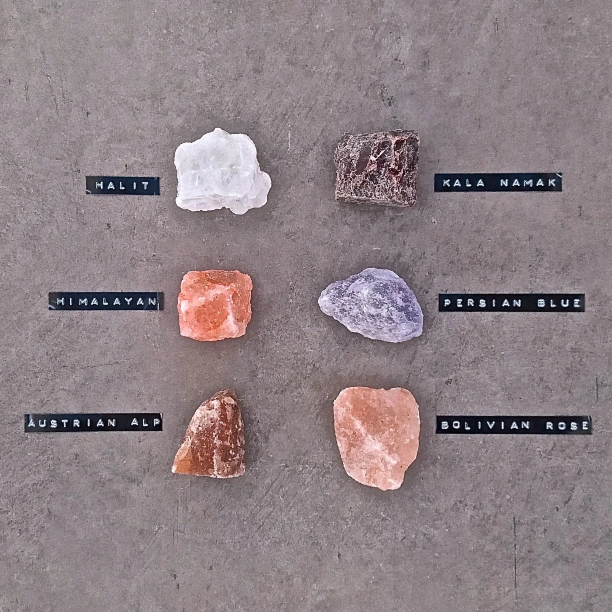 Rivsalt salt rocks labeled Halit, Kala Namak, Himalayan, Persian Blue, Austrian Alp and Bolivian Rose