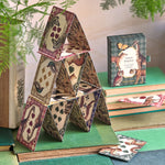 RoomyTown Animal Kingdom Playing Cards built into a house of cards on a green table beside the box