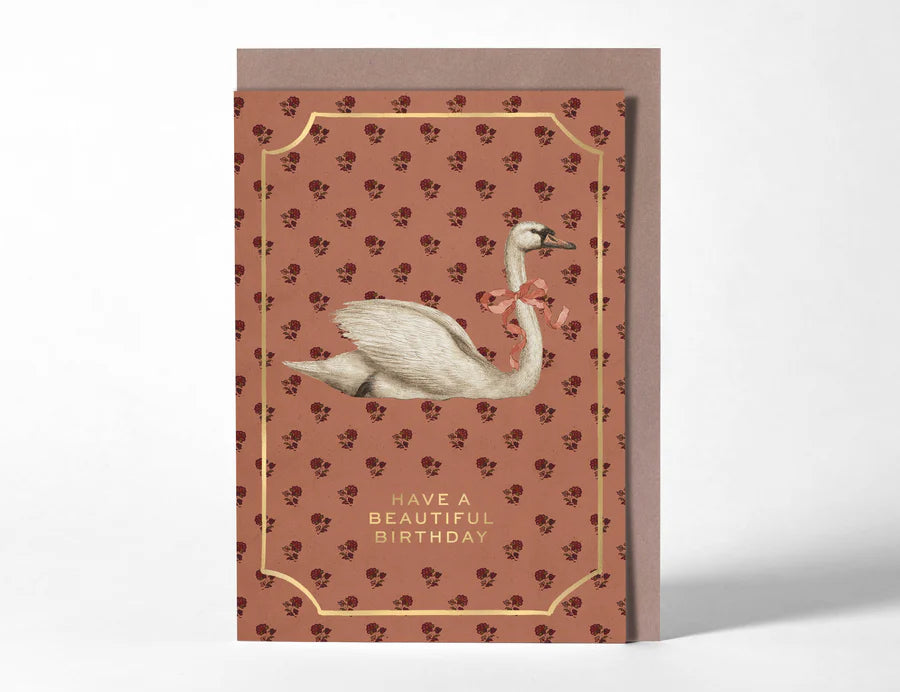 RoomyTown Birthday Swan Greeting Card, a rust red patterned card with a white swan and gold frame