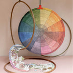 Completed RoomyTown Color Wheel 500-Piece Round Jigsaw Puzzle propped in a gold ring stand