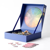 RoomyTown Color Wheel 500-Piece Round Jigsaw Puzzle box open with puzzle pieces spilling out