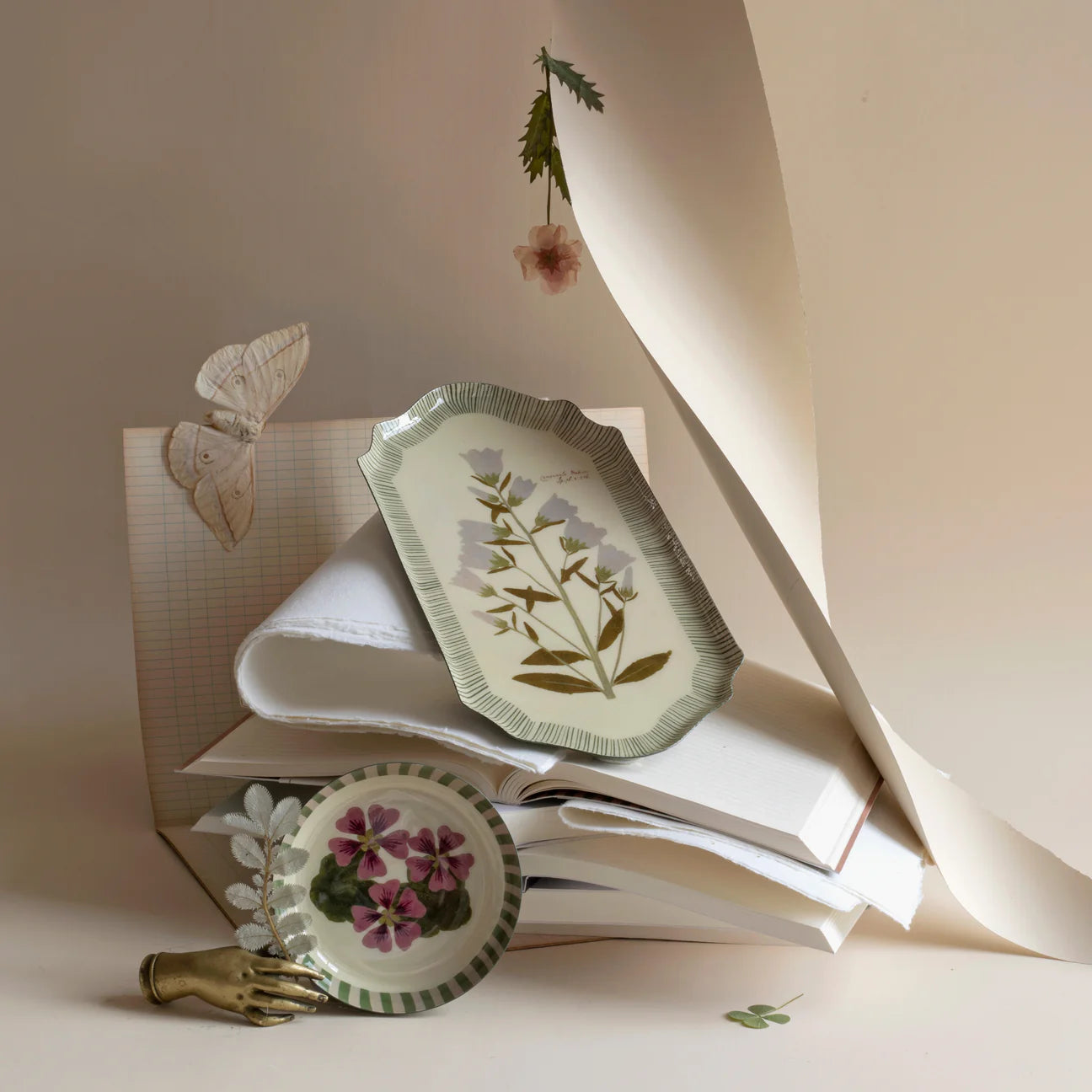 RoomyTown Enamel Trays in Campanula Bellflower and Geranium styled with paper and a butterfly
