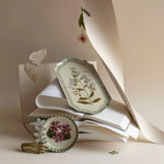 RoomyTown Enamel Trays in Campanula Bellflower and Geranium styled with paper and a butterfly