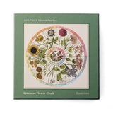 RoomyTown Flower Clock 500-Piece Round Jigsaw Puzzle, a green box with a Linnaean flower clock illustration