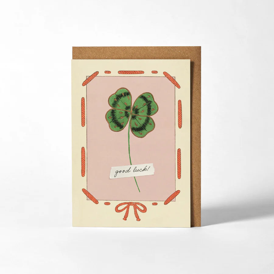 RoomyTown Good Luck Clover Greeting Card, a pink card with a four-leaf clover illustration and kraft envelope
