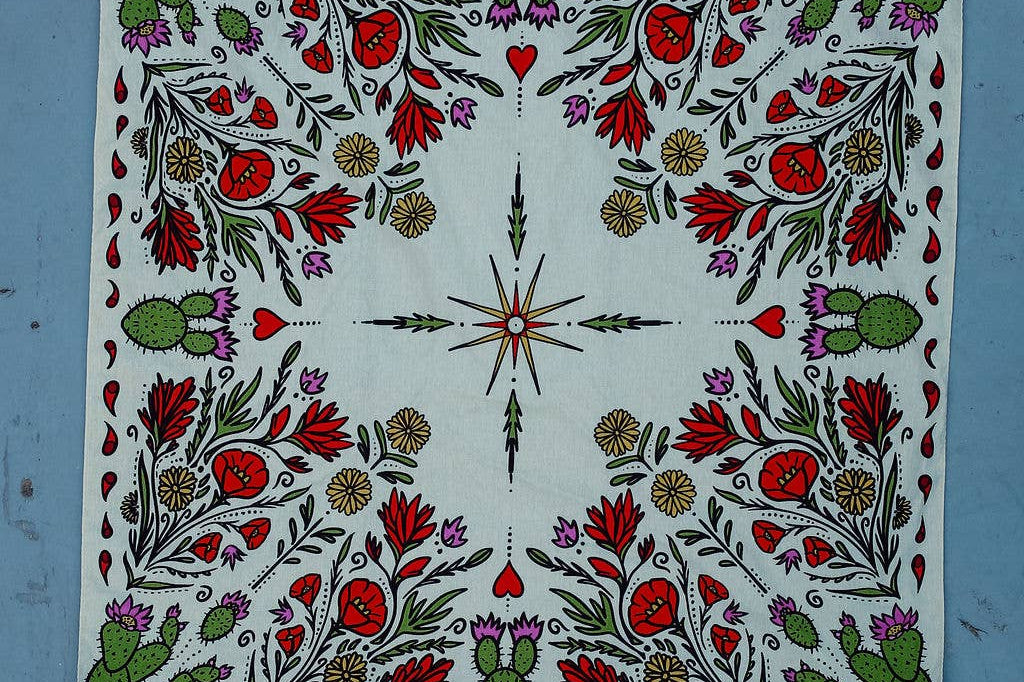 Rooted & Wild Adventure Co. Desert Bloom Bandana laid flat showing the full red and green cactus flower print