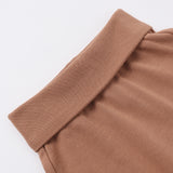 Rylee & Cru Baby Pant in Poppy, close-up of the rust-brown fold-over ribbed waistband