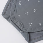 Rylee & Cru Bamboo Short Sleeve Bodysuit in Ocean, close-up of the snap closure and star print