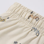 Close-up of the race car print and elastic waistband on the Rylee & Cru Boys Swim Short in Race Car