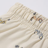 Close-up of the race car print and elastic waistband on the Rylee & Cru Boys Swim Short in Race Car