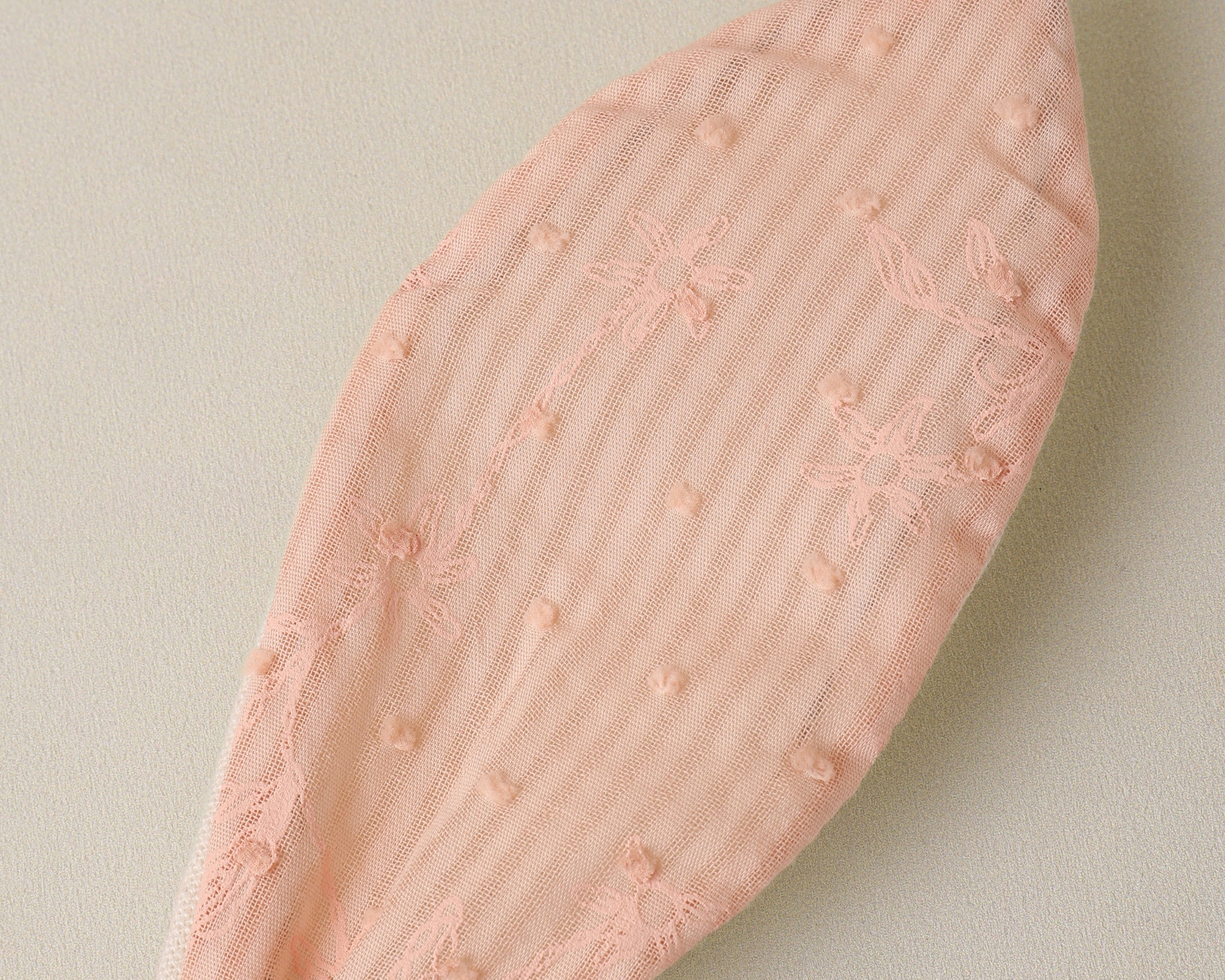 Close-up of the pink textured fabric ear on the Rylee & Cru Bunny Headband in Petal
