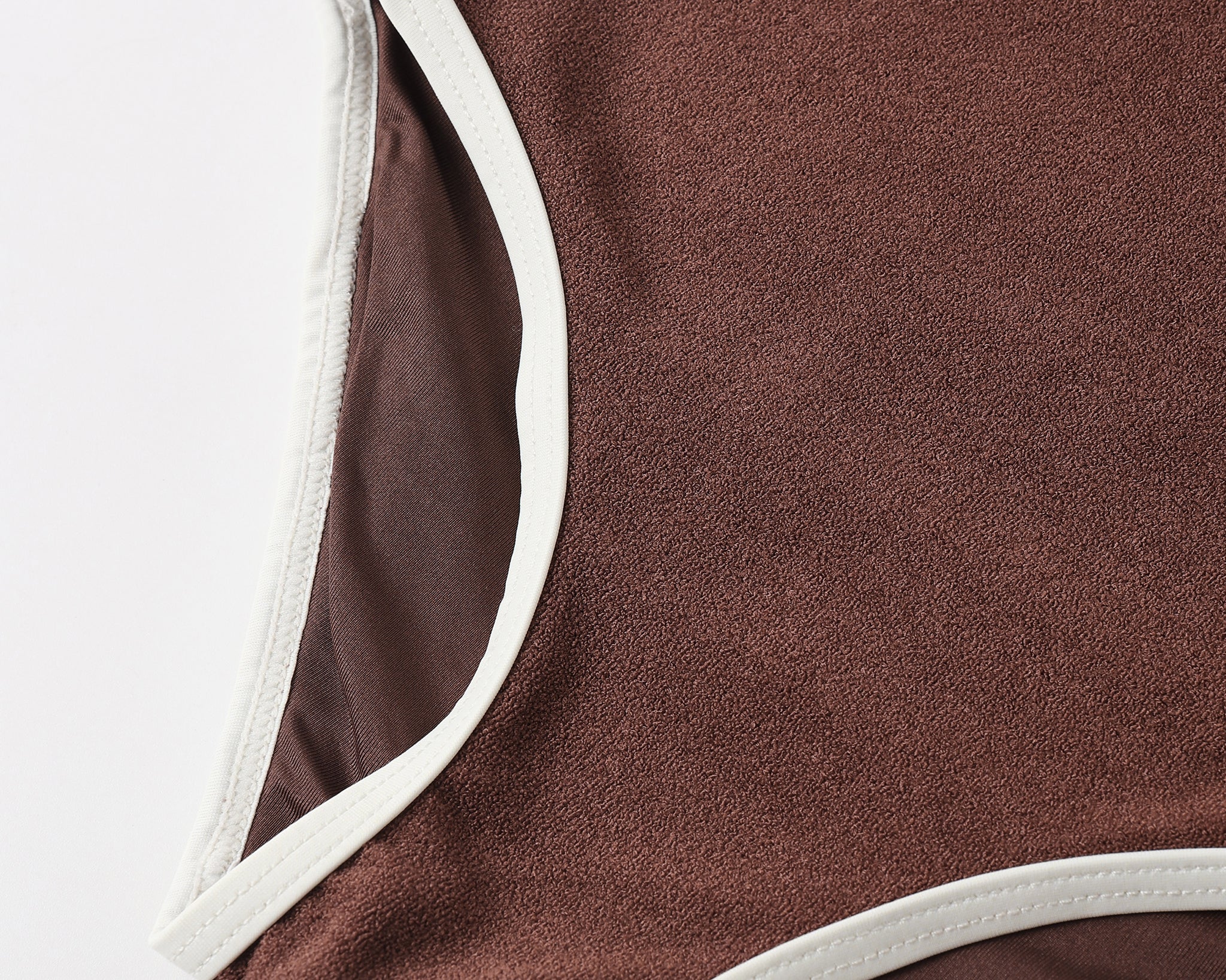 Close-up of the brown ribbed fabric and cream trim on the Rylee & Cru Chocolate Moxie One-Piece