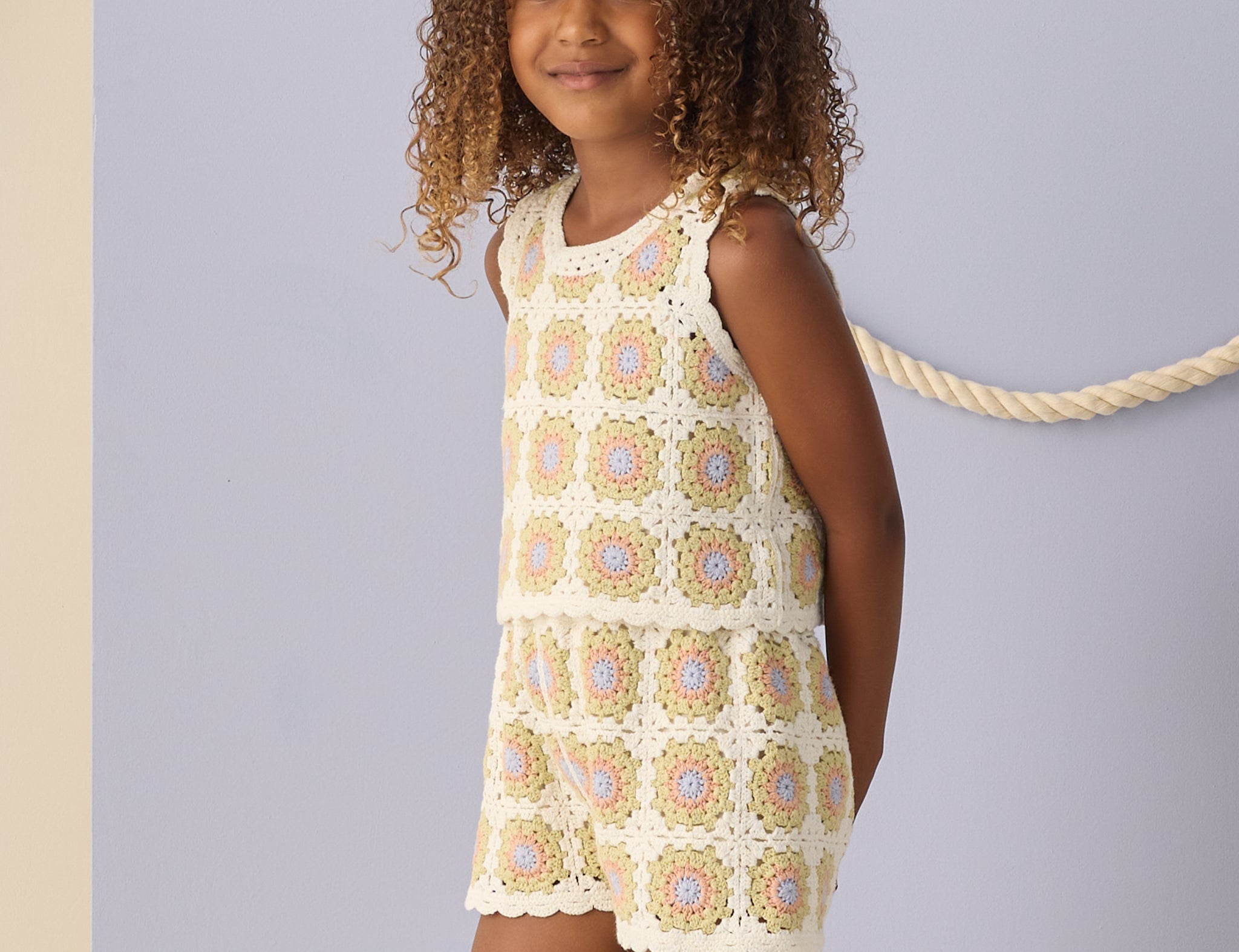 Girl with curly hair wearing the Rylee & Cru Crochet Tank Set in Citron Daisy Check, front view