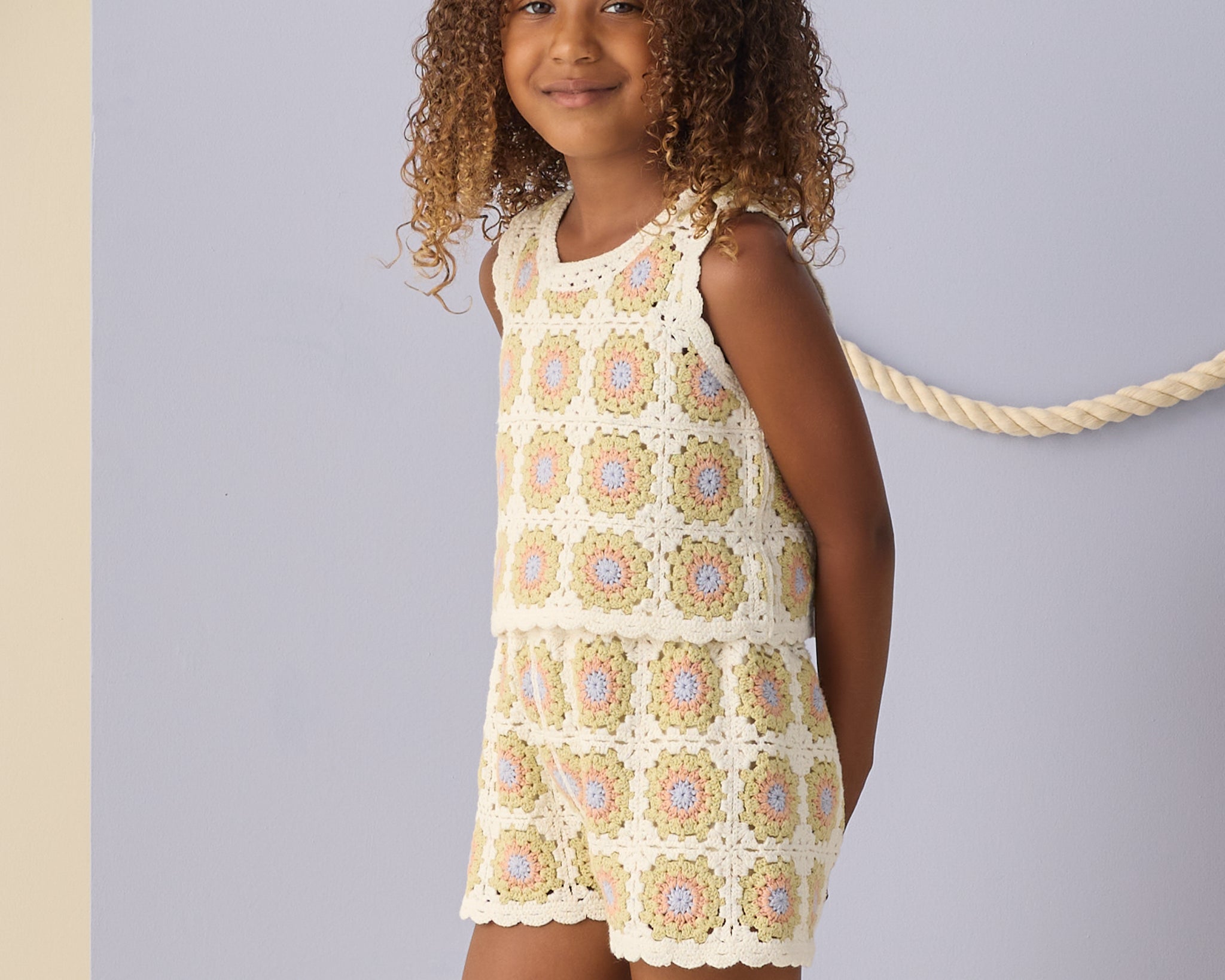 Girl with curly hair wearing the Rylee & Cru Crochet Tank Set in Citron Daisy Check, front view