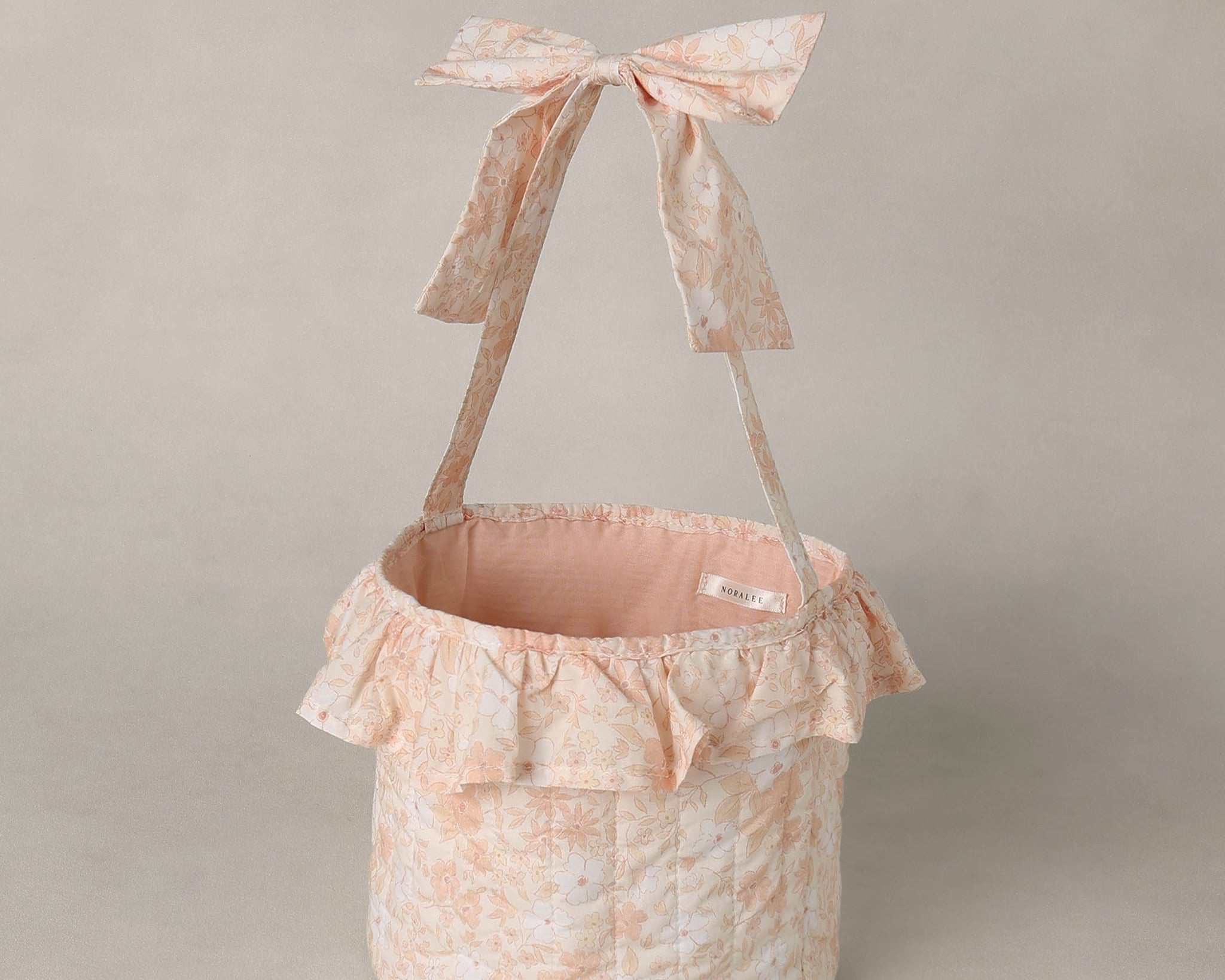 Rylee & Cru Easter Basket in Pastel Garden with a ruffle trim and bow handle, front view
