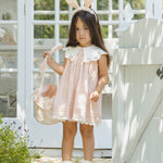 Girl in a pink dress and bunny ears carrying the Rylee & Cru Easter Basket in Pastel Garden