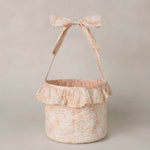 Rylee & Cru Easter Basket in Pastel Garden, a blush floral fabric basket with a ruffle and bow handle