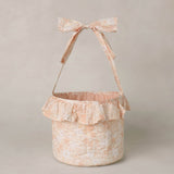 Rylee & Cru Easter Basket in Pastel Garden, a blush floral fabric basket with a ruffle and bow handle