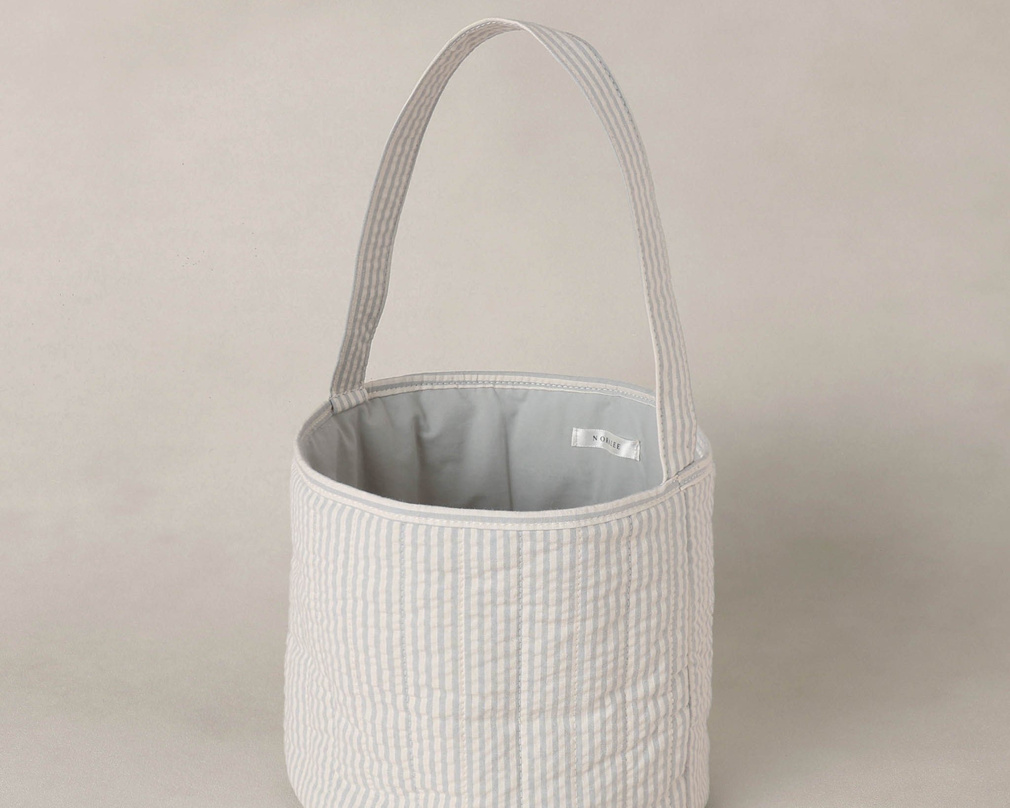 Rylee & Cru Easter Basket in Sky Stripe, front view showing the gray lining