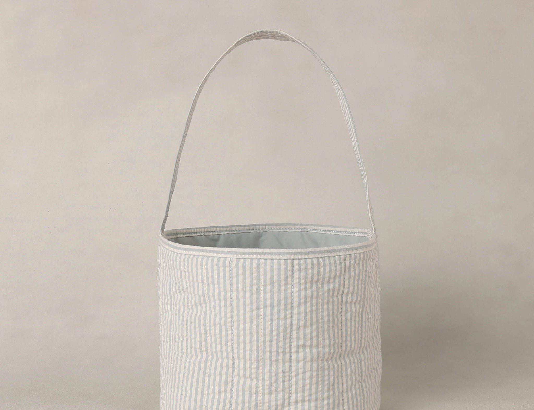 Rylee & Cru Easter Basket in Sky Stripe, a soft blue and white striped fabric basket with a handle