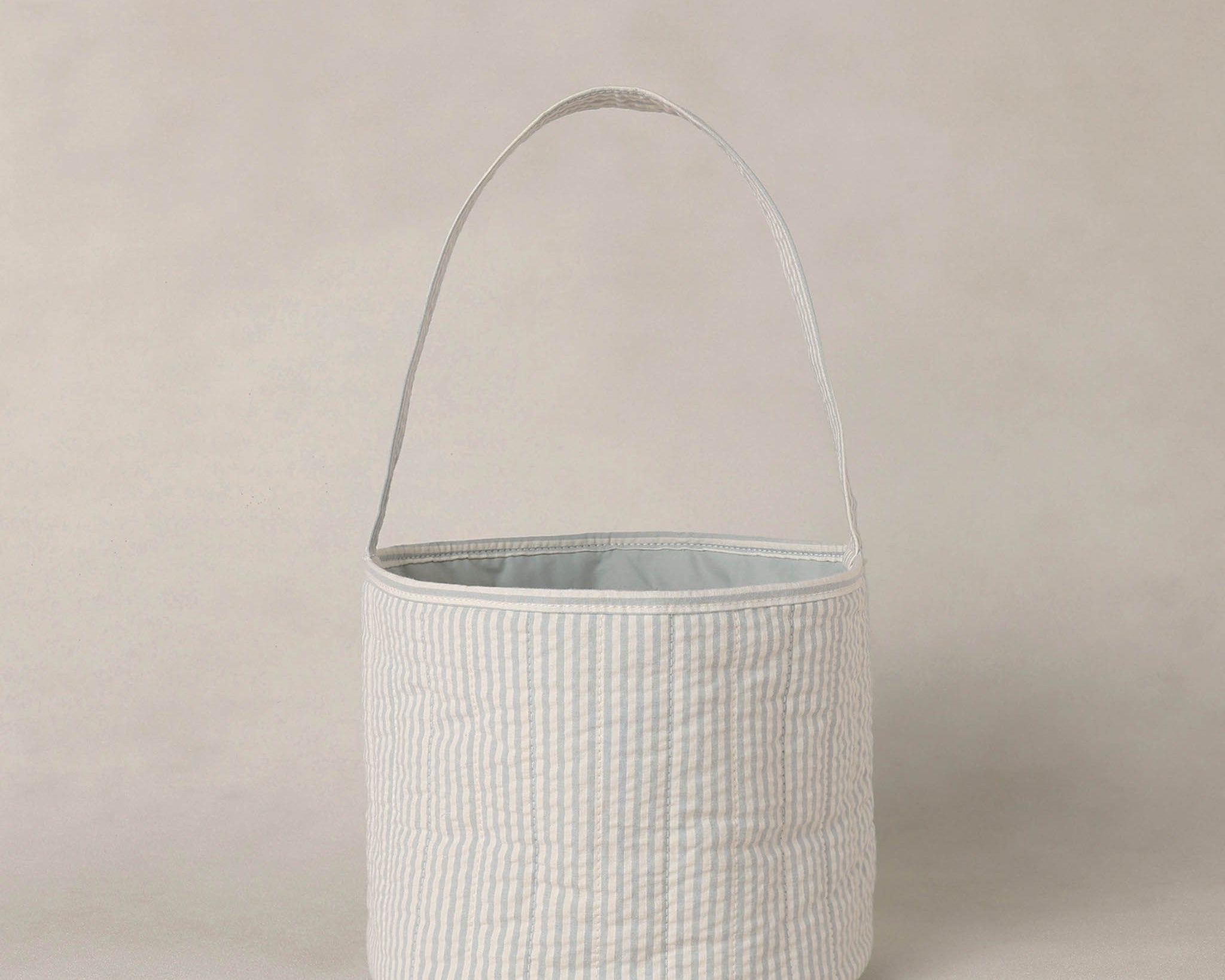 Rylee & Cru Easter Basket in Sky Stripe, a soft blue and white striped fabric basket with a handle