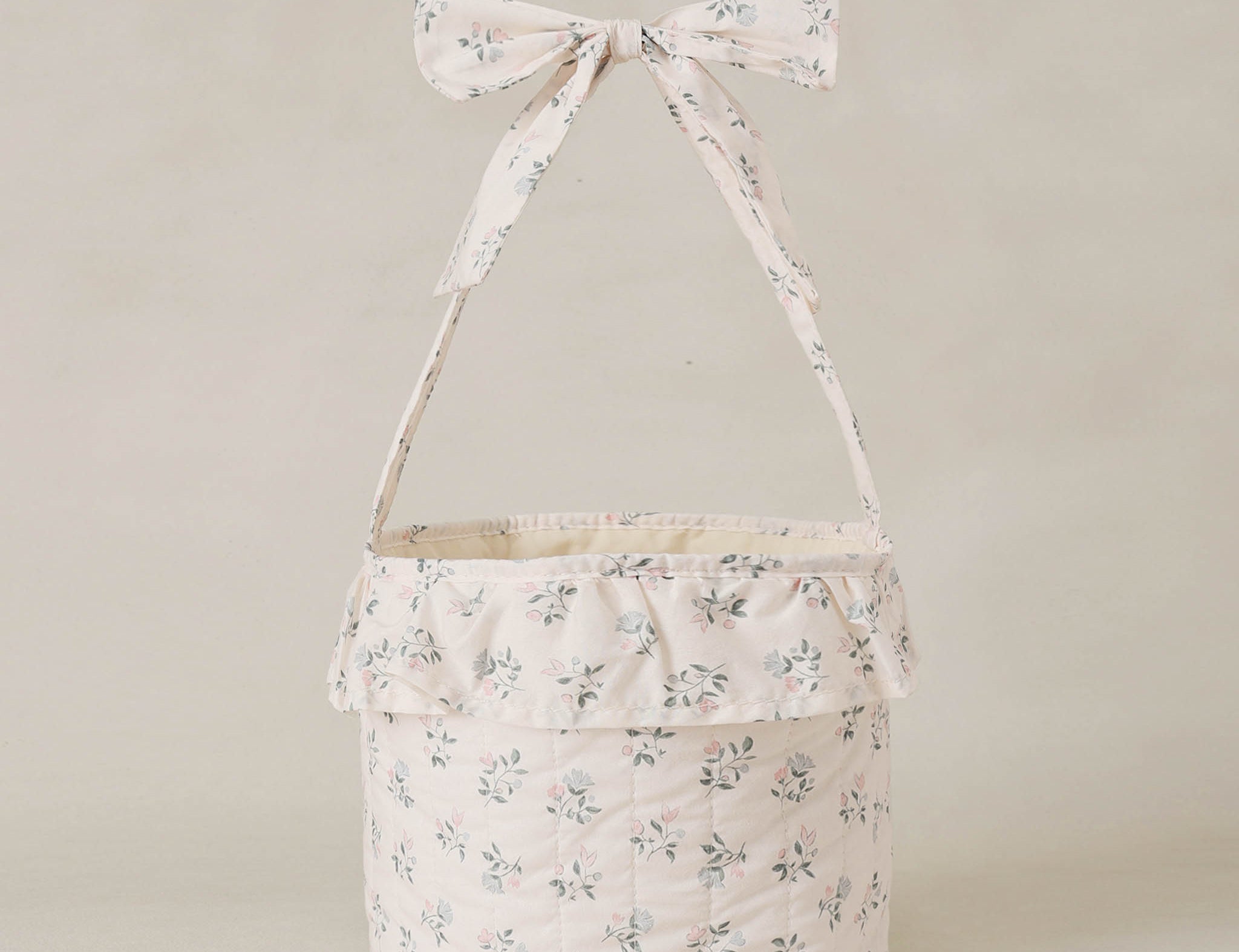 Rylee & Cru Easter Basket in Summer Ditsy, a cream floral fabric basket with a ruffle and bow handle
