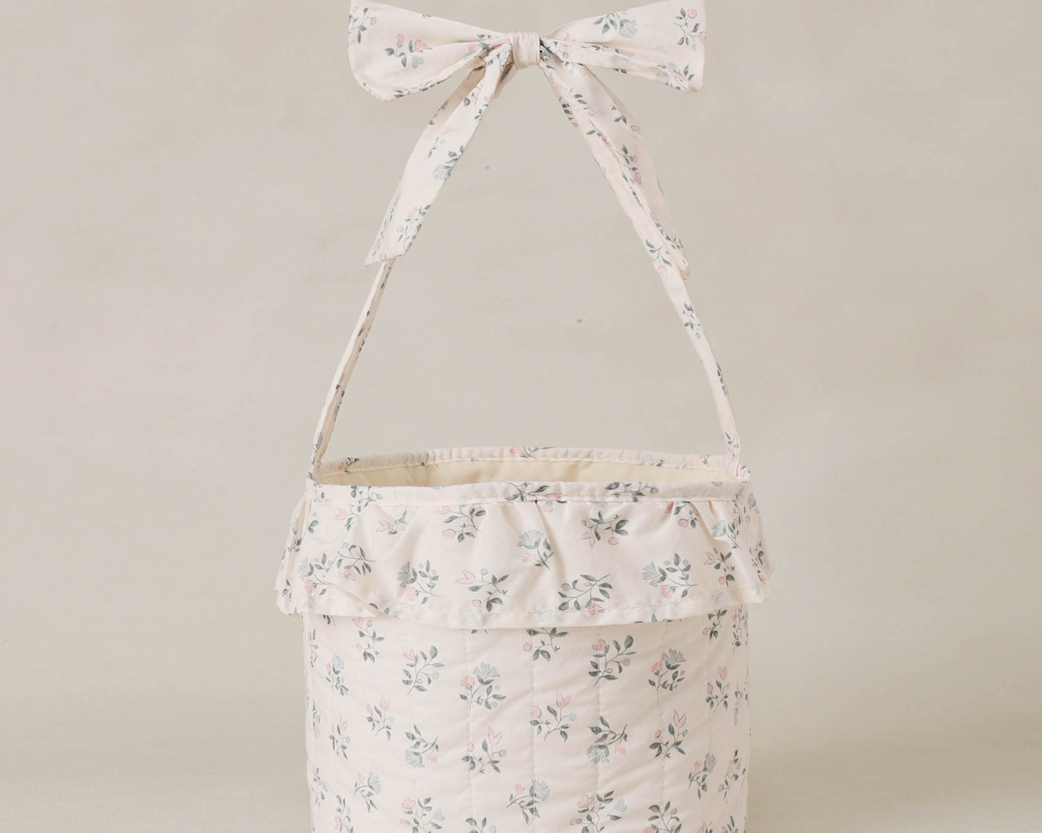Rylee & Cru Easter Basket in Summer Ditsy, a cream floral fabric basket with a ruffle and bow handle
