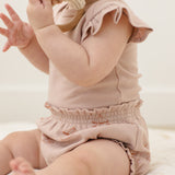 Baby from behind wearing the Rylee & Cru Flutter Sleeve Bodysuit in Blush with ruffle bloomers
