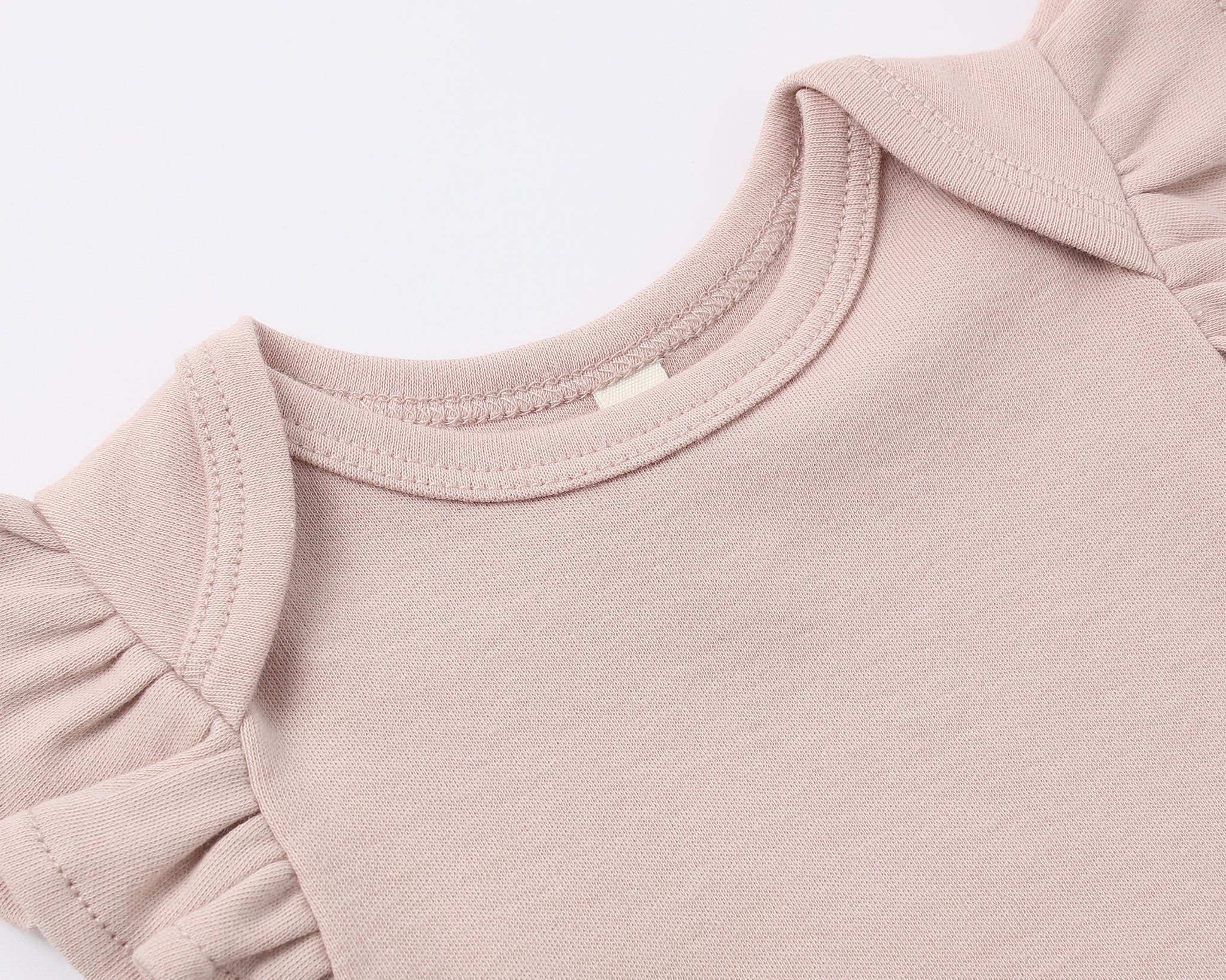 Close-up of the ruffled flutter sleeve on the Rylee & Cru Flutter Sleeve Bodysuit in Blush