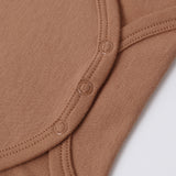 Close-up of the snap closures on the Rylee & Cru Flutter Sleeve Bodysuit in Poppy