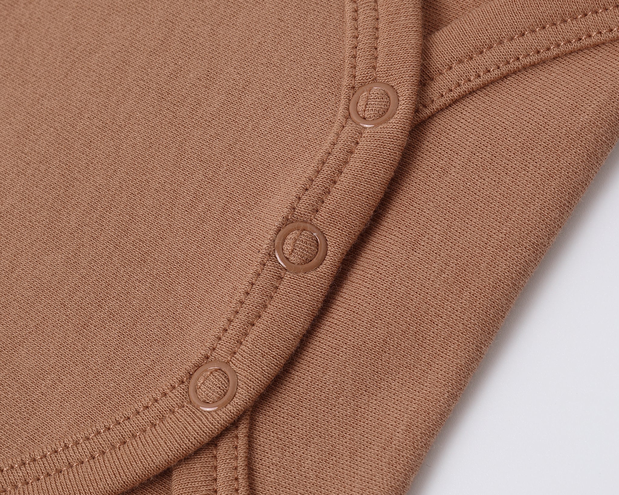Close-up of the snap closures on the Rylee & Cru Flutter Sleeve Bodysuit in Poppy