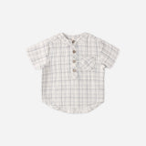 Rylee & Cru Jaxson Shirt in Blue Plaid, a cream and blue plaid short-sleeve henley with wooden buttons, laid flat
