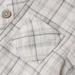 Close-up of the chest pocket and wooden button on the Rylee & Cru Jaxson Shirt in Blue Plaid