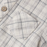 Close-up of the chest pocket and wooden button on the Rylee & Cru Jaxson Shirt in Blue Plaid