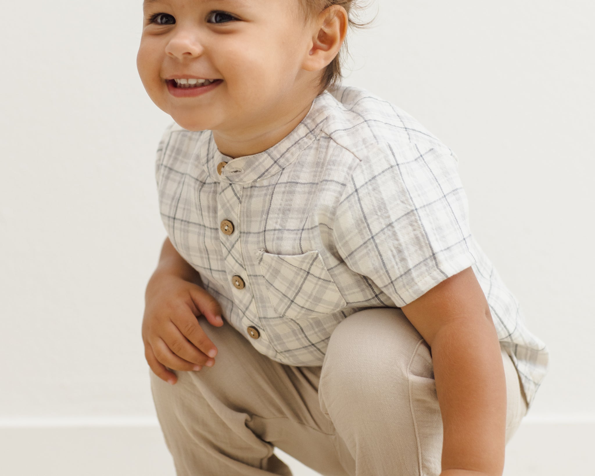 Laughing toddler crouching in the Rylee & Cru Jaxson Shirt in Blue Plaid