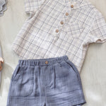 Rylee & Cru Jaxson Shirt in Blue Plaid laid flat with blue gauze shorts