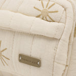 Rylee & Cru Mini Backpack in Sunburst, close-up of the gold sun print and Quincy Mae label