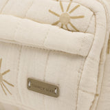 Rylee & Cru Mini Backpack in Sunburst, close-up of the gold sun print and Quincy Mae label