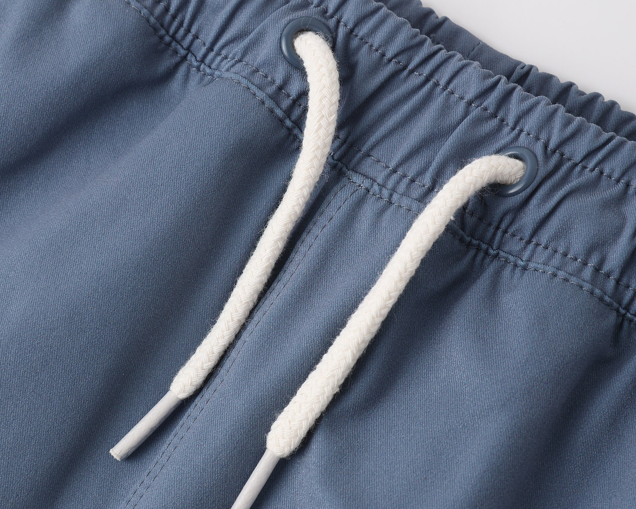 Close-up of the drawstring waistband on the Rylee & Cru Paneled Boardshort in Marine