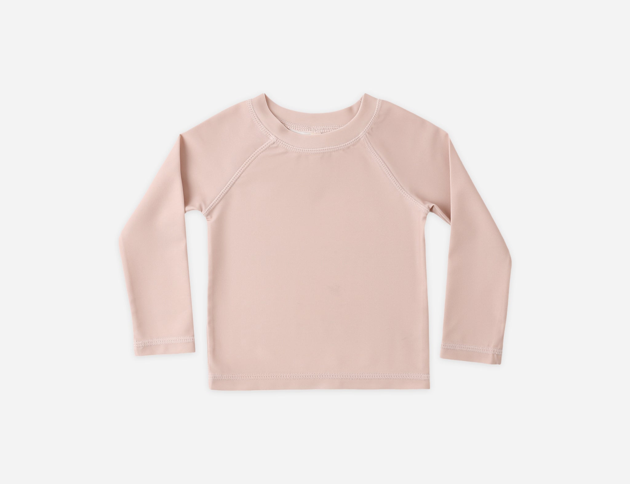 Rylee & Cru Rashguard Long Sleeve in Blush, a pale pink baby swim top, laid flat