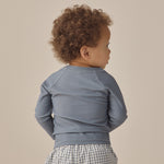 Back view of a toddler wearing the Rylee & Cru Rashguard Long Sleeve in Ocean