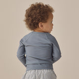 Back view of a toddler wearing the Rylee & Cru Rashguard Long Sleeve in Ocean