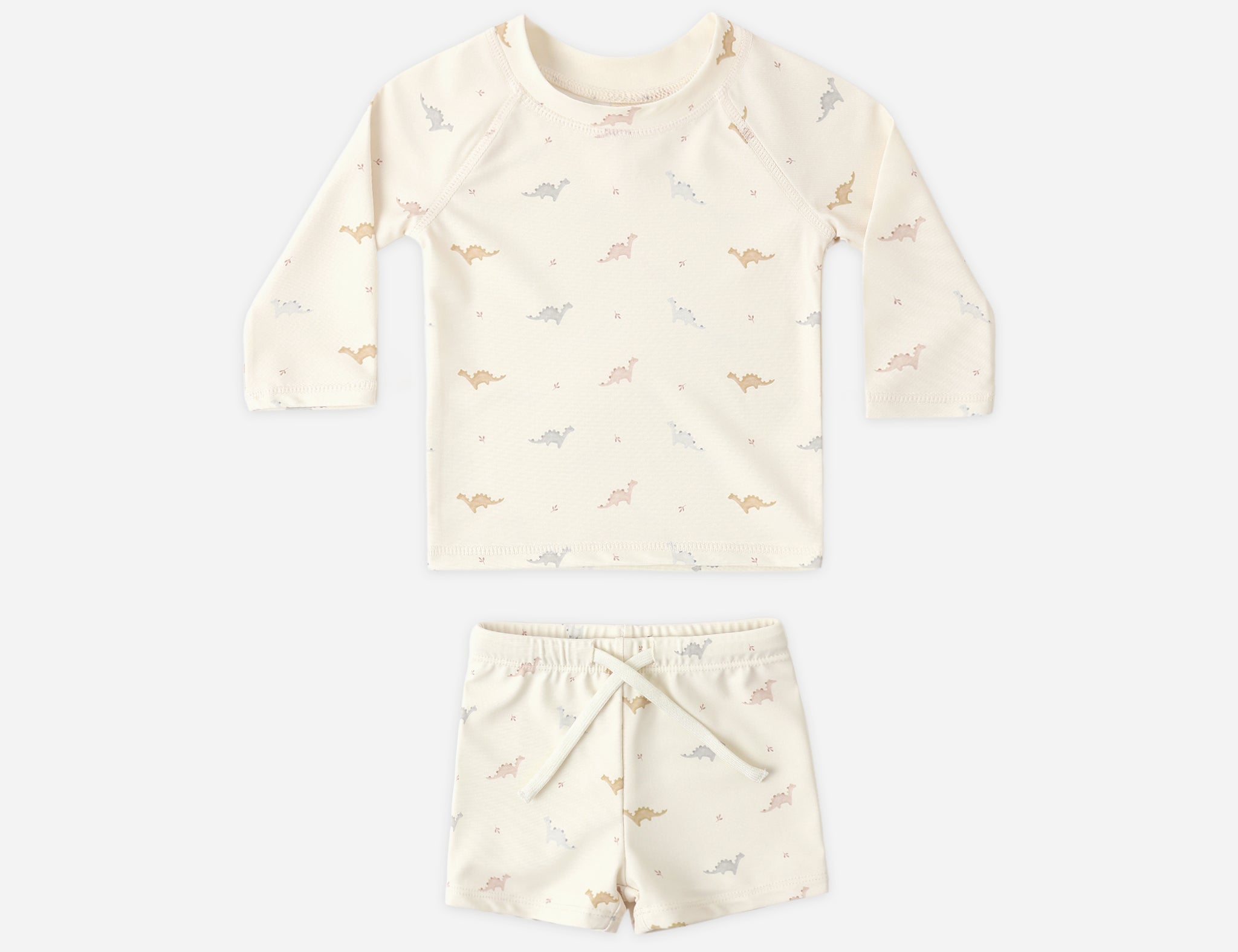 Rylee & Cru Rashguard Top + Short Set in Dino, a cream long-sleeve swim top and shorts with a small dinosaur print
