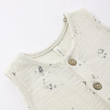 Close-up of the rocket, planet and star print and wooden buttons on the Rylee & Cru Romper in Space