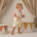Toddler walking past striped drums wearing the Rylee & Cru Romper in Space