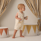 Toddler walking past striped drums wearing the Rylee & Cru Romper in Space