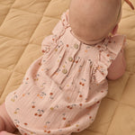 Back view of the Rylee & Cru Ruffle Romper in Cherries showing the wooden button closure