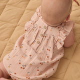 Back view of the Rylee & Cru Ruffle Romper in Cherries showing the wooden button closure