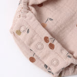 Close-up of the snap closures and cherry print on the Rylee & Cru Ruffle Romper in Cherries