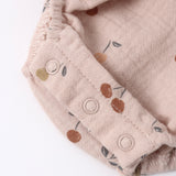 Close-up of the snap closures and cherry print on the Rylee & Cru Ruffle Romper in Cherries